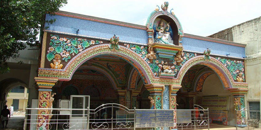An image of Sarasvati Mahal Library interior, showcasing rows of ancient books.