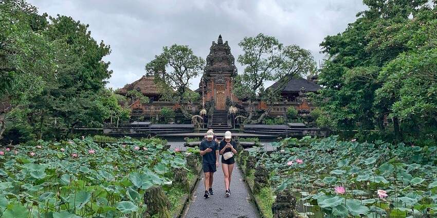 Tourists near the lotus pond in front of the Saraswati Temple.