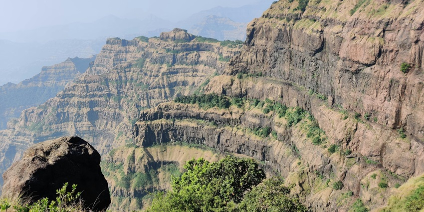 An aerial view of majestic peaks in Satara, Maharashtra decked with lush green vegetation.