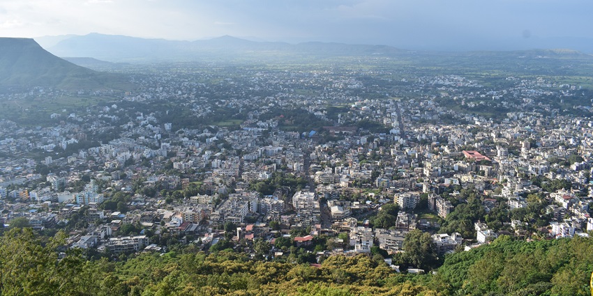 Image of the beautiful foothill city surrounded by hills and lush green jungle