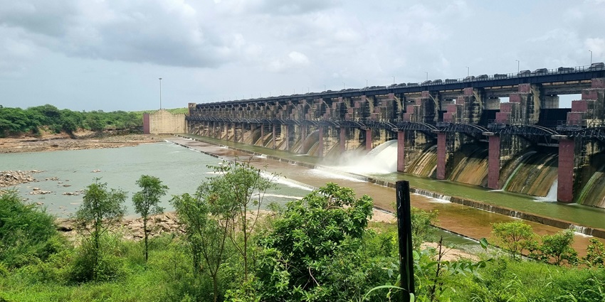 Sathanur Dam reservoir with sunset reflections, landscaped gardens, and nearby crocodile farm, near Pachaiamman temple.