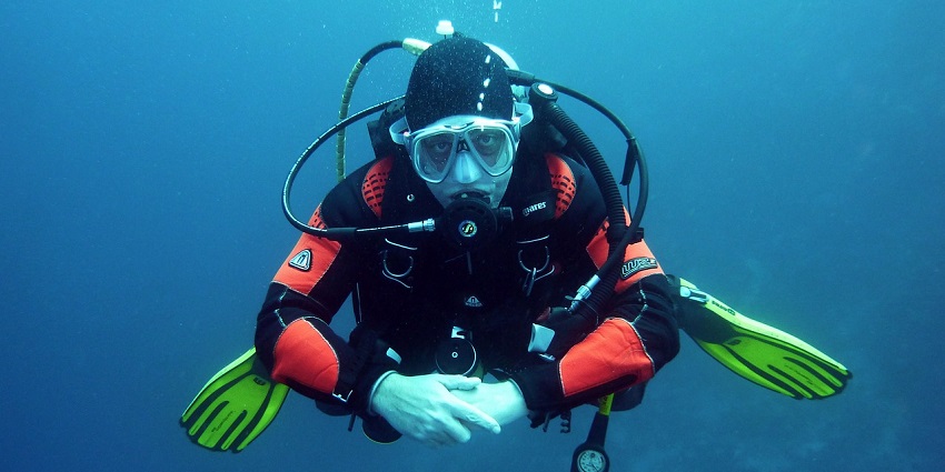 A picture of a diver exploring the vibrant marine life - Alibaug Beach water sports.