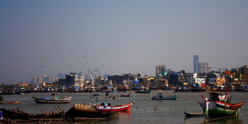 Madh Jetty featuring boats on calm waters with a clear sky above