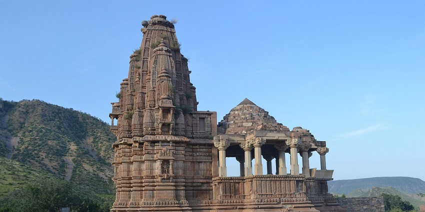 An image of the Mangla Devi Temple with stunning architecture in a lush landscape.