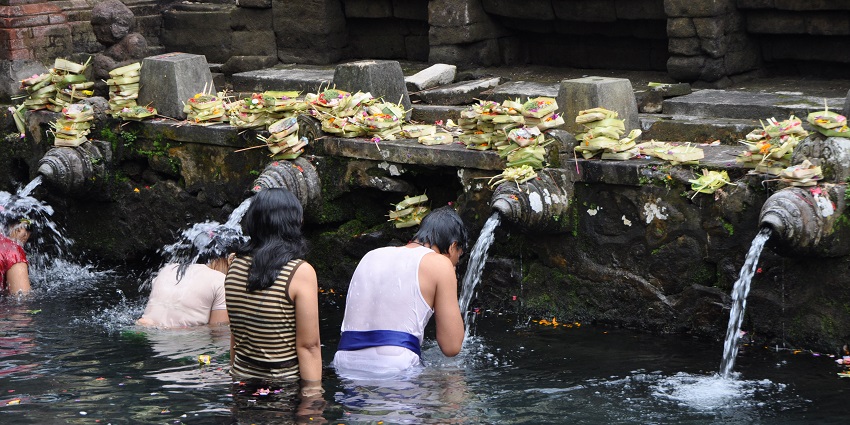 Devotees bathing in the Purification Pool at Tirta Empul Temple, , one of the things to do in Bali.