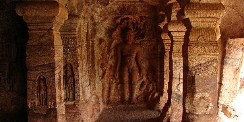 Intricate wall relief in Jain cave temple, reminiscent of Ekvira Temple's art.