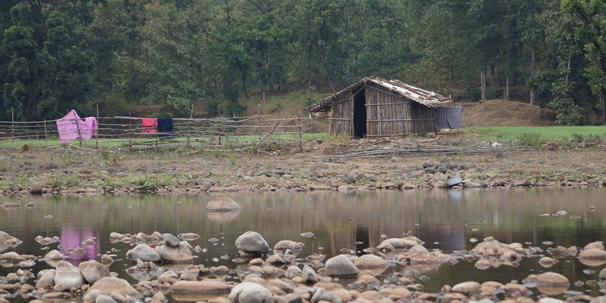 View of the hut and still water reflection of "Semadoh" Village near Gugamal National Park