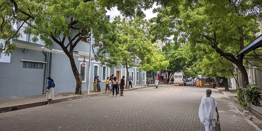 Ashram surrounded by lush greenery and serene atmosphere