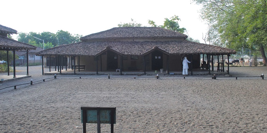A sandy courtyard in front of Adi Nivas at Sevagram Ashram