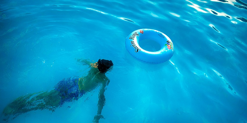 An image of a boy swimming in a pool at one of the best water parks in Matheran.
