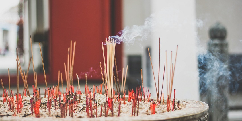 Image of incense sticks in a temple lighten up beautifully during day time view