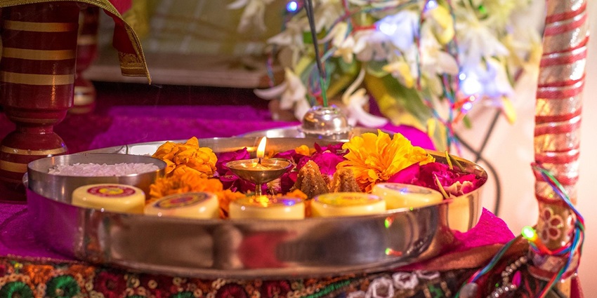 Image of pooja thali decorated with flowers incense stick and other hindu ritual items