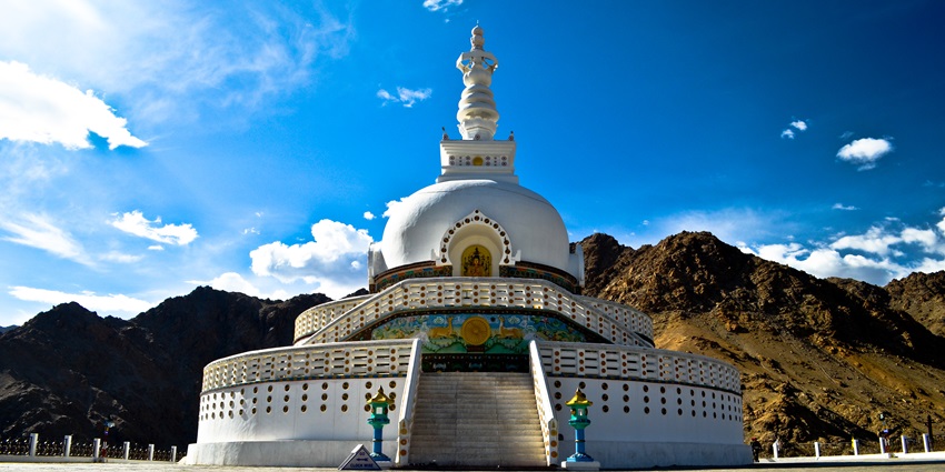 Shanti Stupa is a white-domed structure, perched on a hilltop.