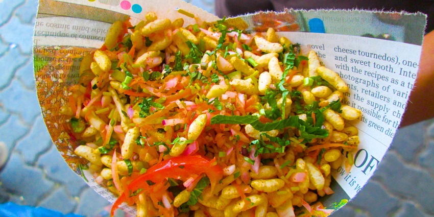 Bhel puri, a dish of puffed rice topped with chopped onions, tomatoes, coriander and sev