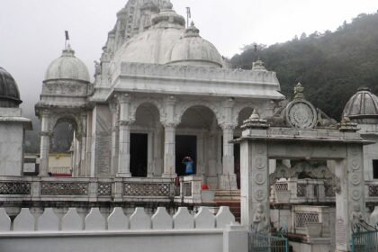 A Jain temple built with white marble is situated in a large area amidst greenery