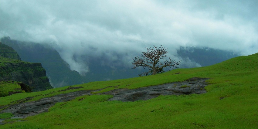 Vast plateau near Nanaghat caves in the Western Ghats surrounded by hills covered in mist