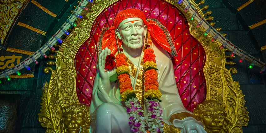 Sri Sai Baba Temple, Shirdi decorated with flowers and devotees are seen worshipping.