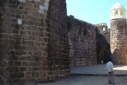 Shirgaon Fort with its sturdy stone walls and watchtowers, set against a backdrop of clear skies