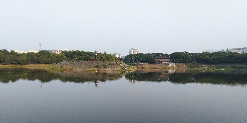 Tranquil lake, surrounded by verdant hills, perfect for relaxation.