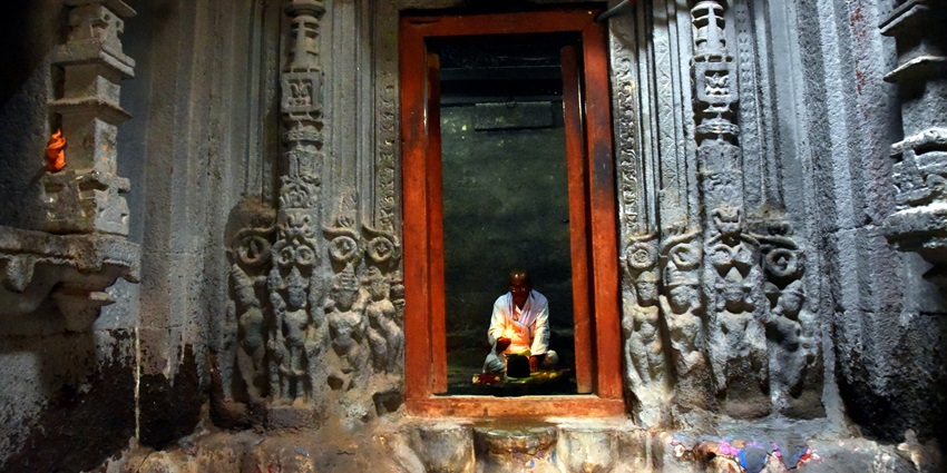 A peaceful view of the stone entrance of the temple is decorated with beautiful carvings.