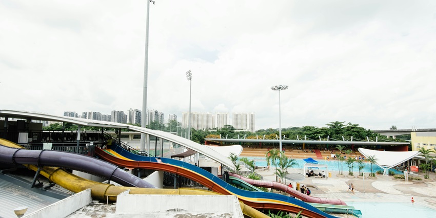 Image of a waterpark view from far with colourful and thrilling waterslides to ride