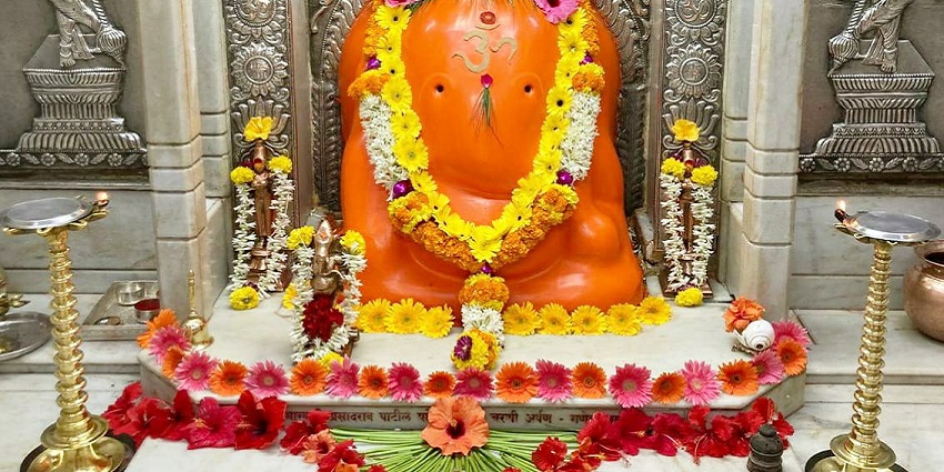 Astavinayak Ganpati statue in Theur, Pune, adorned with vibrant colors and details.