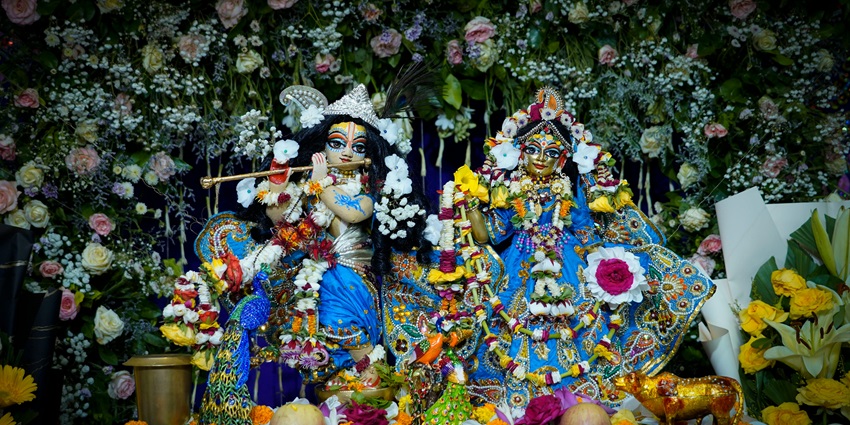 A glimpse of idols of God decorated with vibrantly coloured clothes and gold jewels.