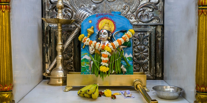 A shrine featuring a statue of a Hindu god, reflecting the beauty of devotion.