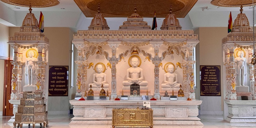 Image of a jain temple’s interior design with stunning architecture and while dim lights decorated