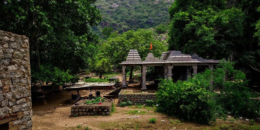 White and black concrete building near green trees during daytime - ancient temples in Pune