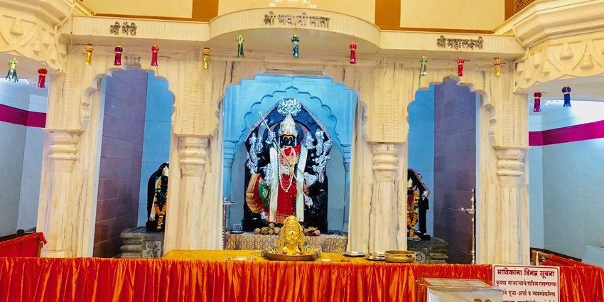 A picture of the inner prayer sanctum of a temple in Pune with a decorated idol of Goddess Waghjai