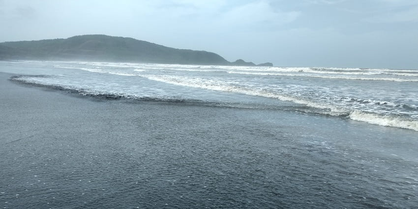 A panoramic view of Shrivardhan Beach in Raigad with calm waves