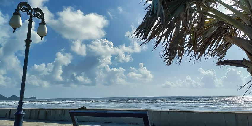Serene view of Shrivardhan Beach with golden sands and gentle ocean waves