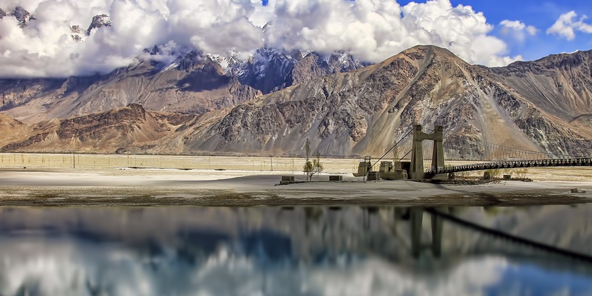 Saling Bridge spanning the Shyok River in Khaplu, Gilgit-Baltistan, with rugged mountains in the background