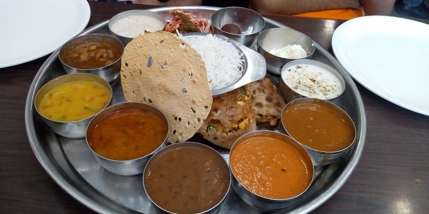 A traditional Maharashtrian thali with roti, dal and sabzi, the best food in Solapur.