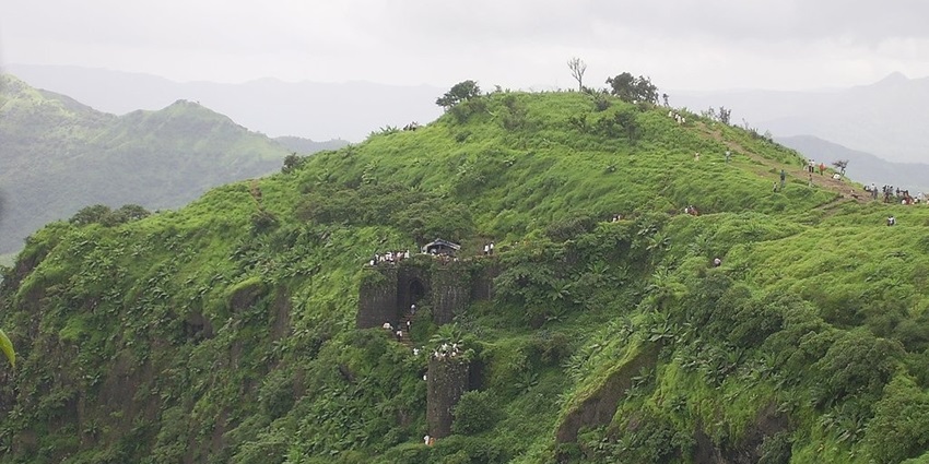 A picture captured from Sinhagad Fort, showcasing lush greenery and historic ruins.