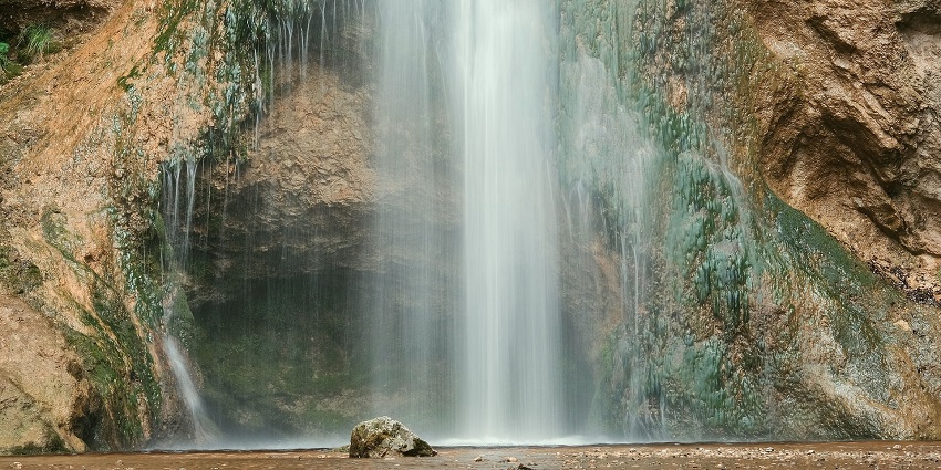 A picture of Siruvani cascade amidst dense greenery, offering a stunning waterfall view.