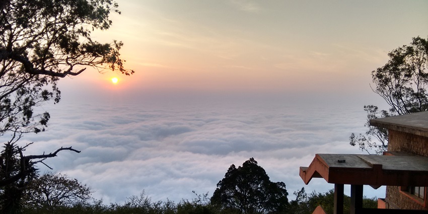 The hilltop view of Skandagiri above the clouds, a place to visit near Bangalore in summer