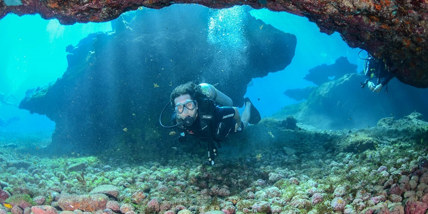 A picture of snorkelers inside vibrant coral reefs off the shore of Chivla Beach.