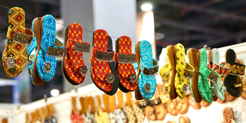 Image of sandals hanging in a market for wedding footwear and other things for shopping