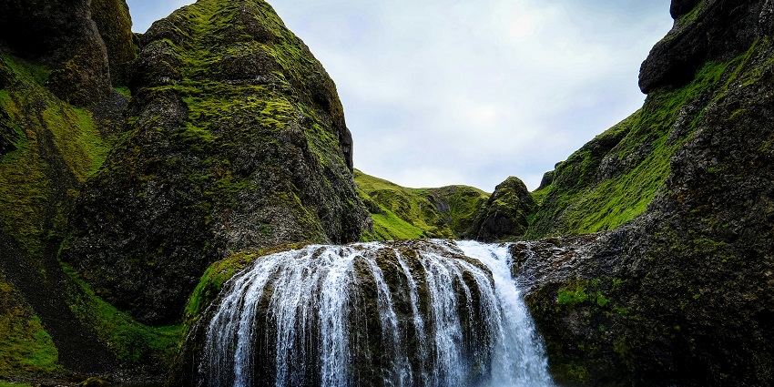 The cascading Someshwar Falls, majestic waterfalls surrounded by lush green vegetation.