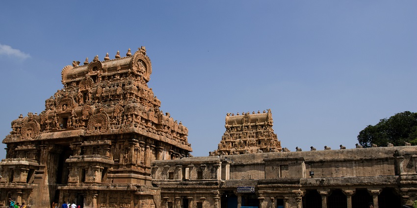 An image of people standing in front of an ancient Soundararajaperumal temple.