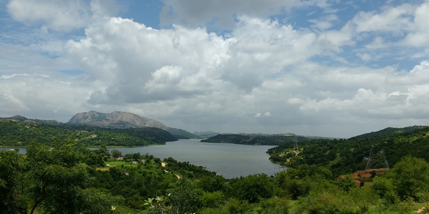 An aerial view of the scenic Manchanabele Dam with lush greenery on both sides
