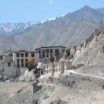 A breathtaking view of the monastery perched atop the hills with rocky backdrop.