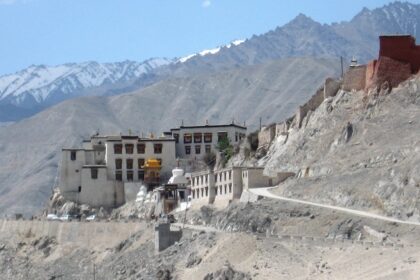 A breathtaking view of the monastery perched atop the hills with rocky backdrop.