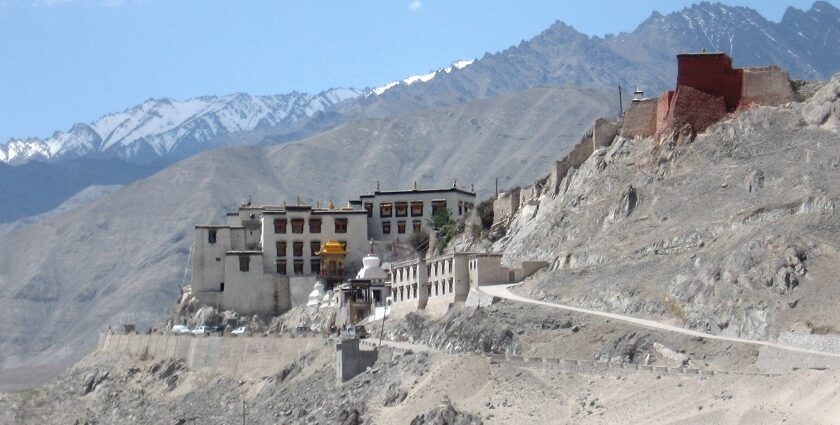 A breathtaking view of the monastery perched atop the hills with rocky backdrop.