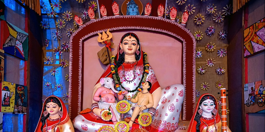 Religious display of Goddess Durga during Puja, featuring intricate decorations and vibrant colours