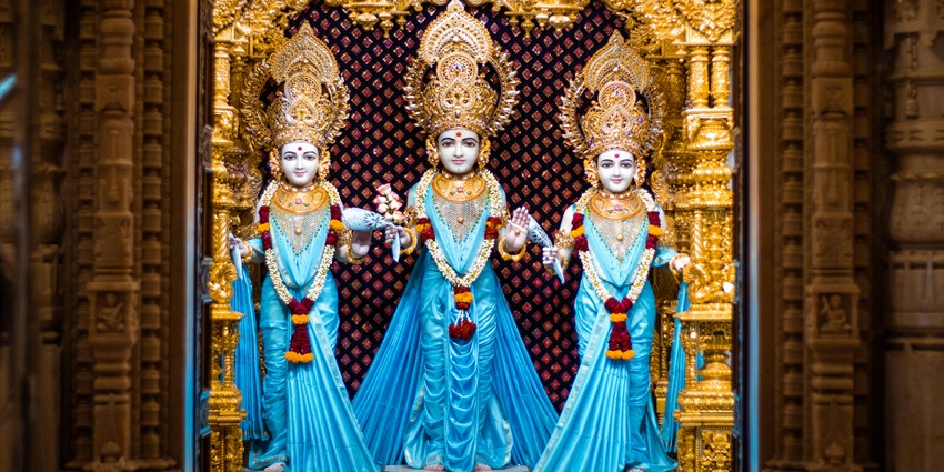 Statues of Hindu goddesses displayed together, showcasing intricate details and vibrant colours