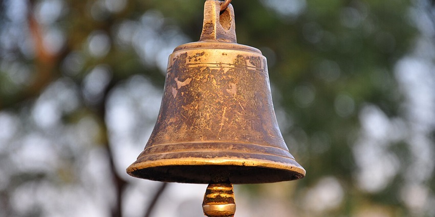 Image of a bell hanging near the water pond at the Thousand Pillar Temple