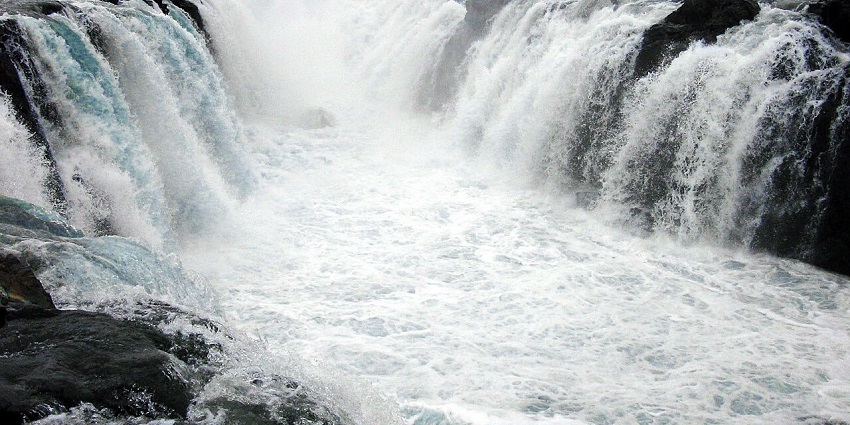 An image of the majestic waterfall cascading through dense forests, perfect for nature lovers.